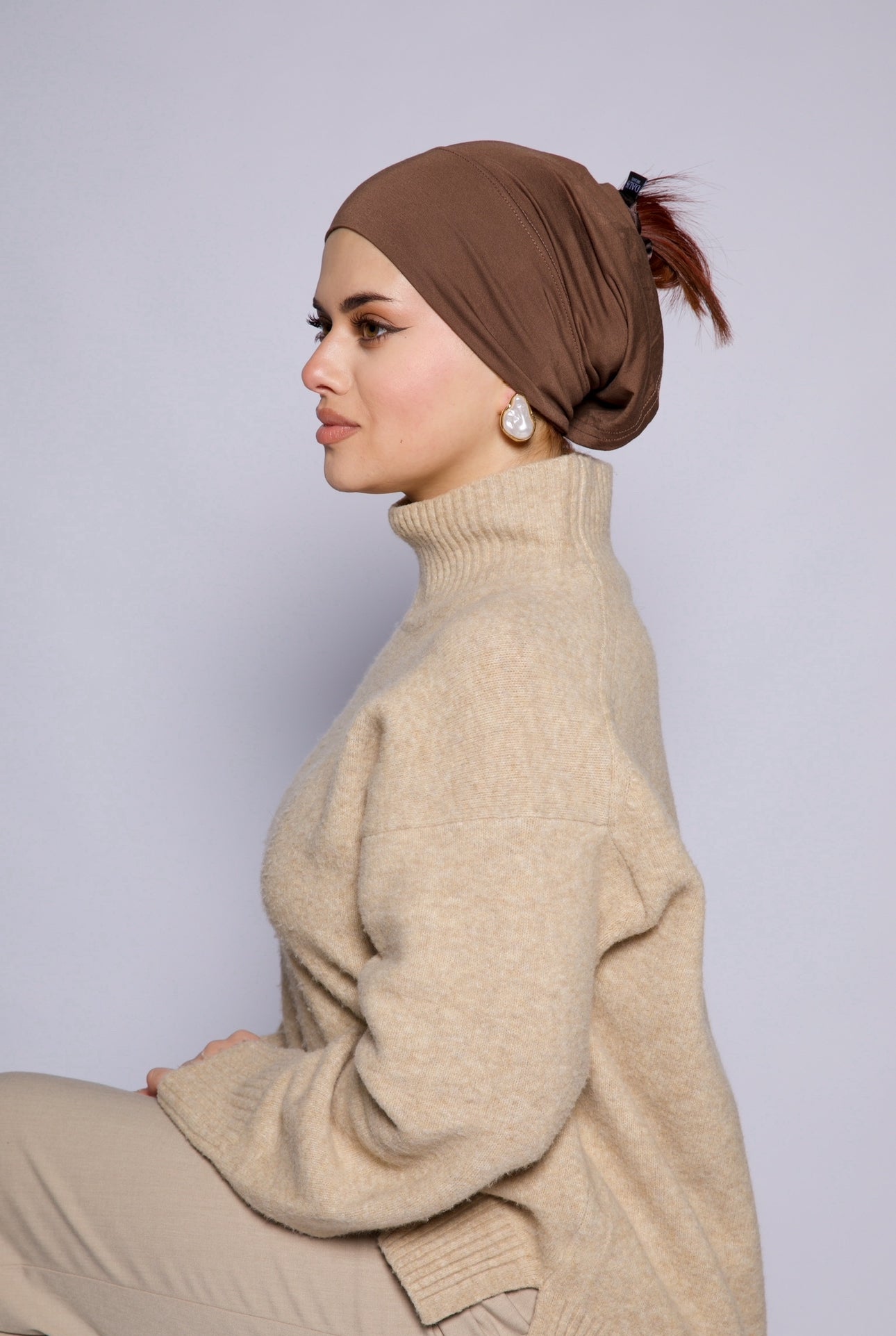 lady turned to her side showcasing a mid brown bamboo undercap without the hijab